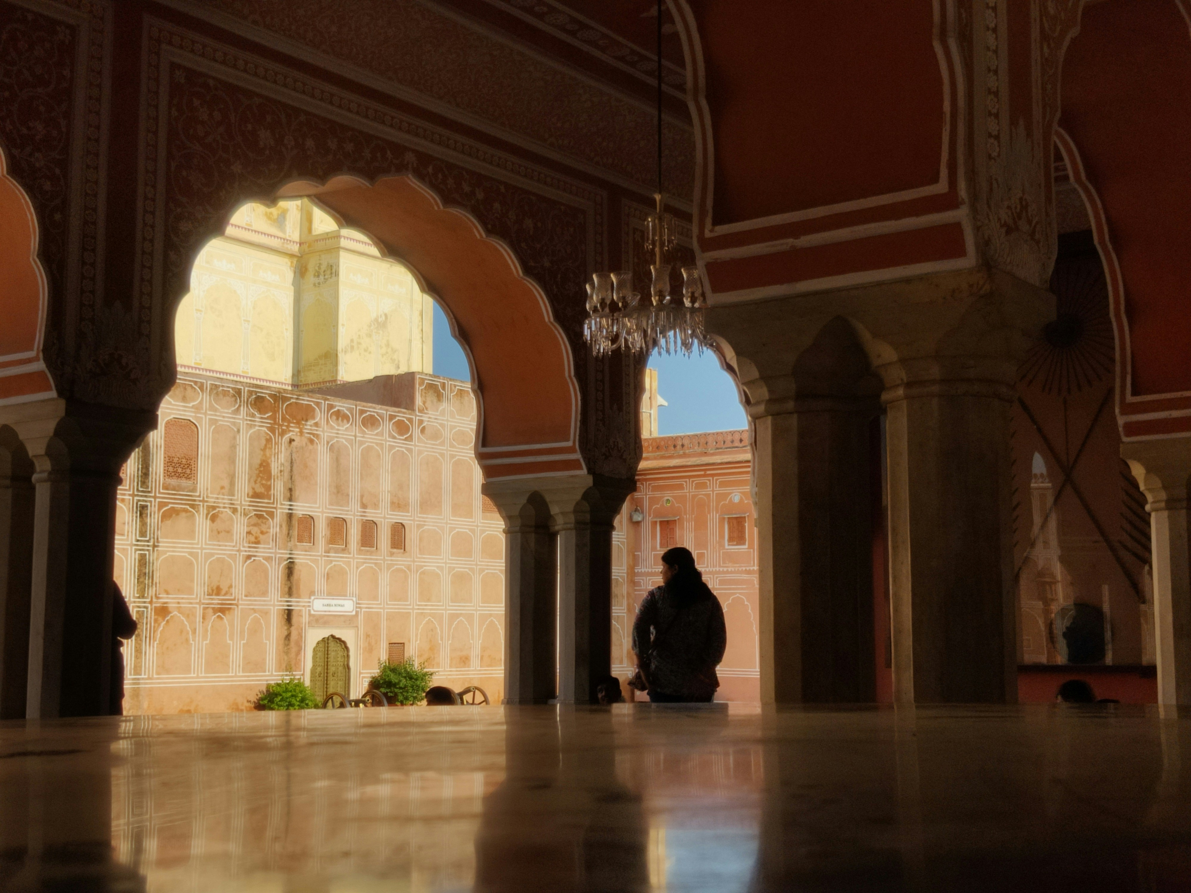 A person sitting on a bench in a building