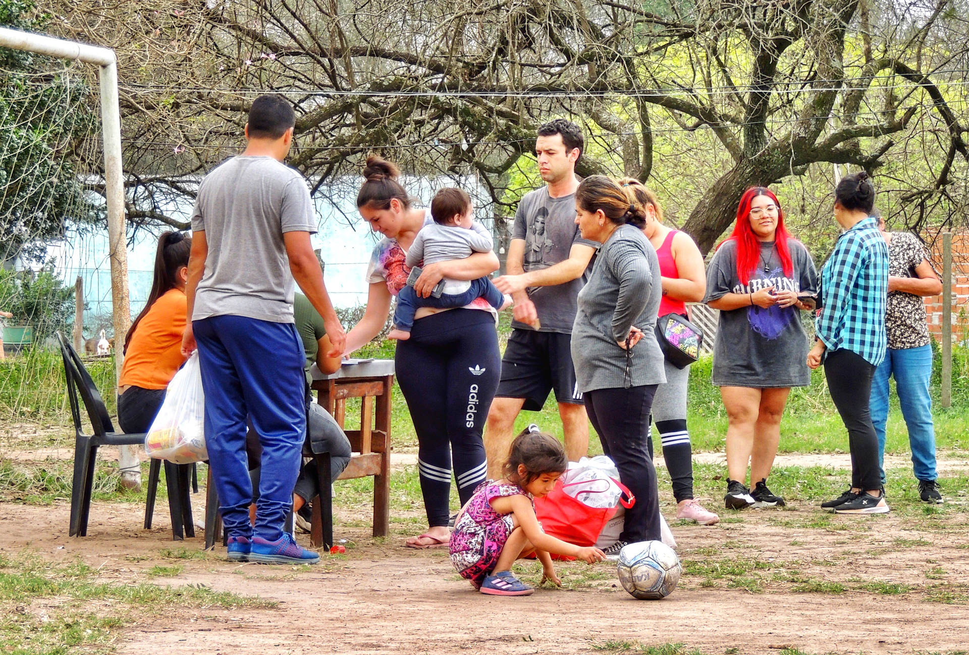 A group of people standing around a soccer goal