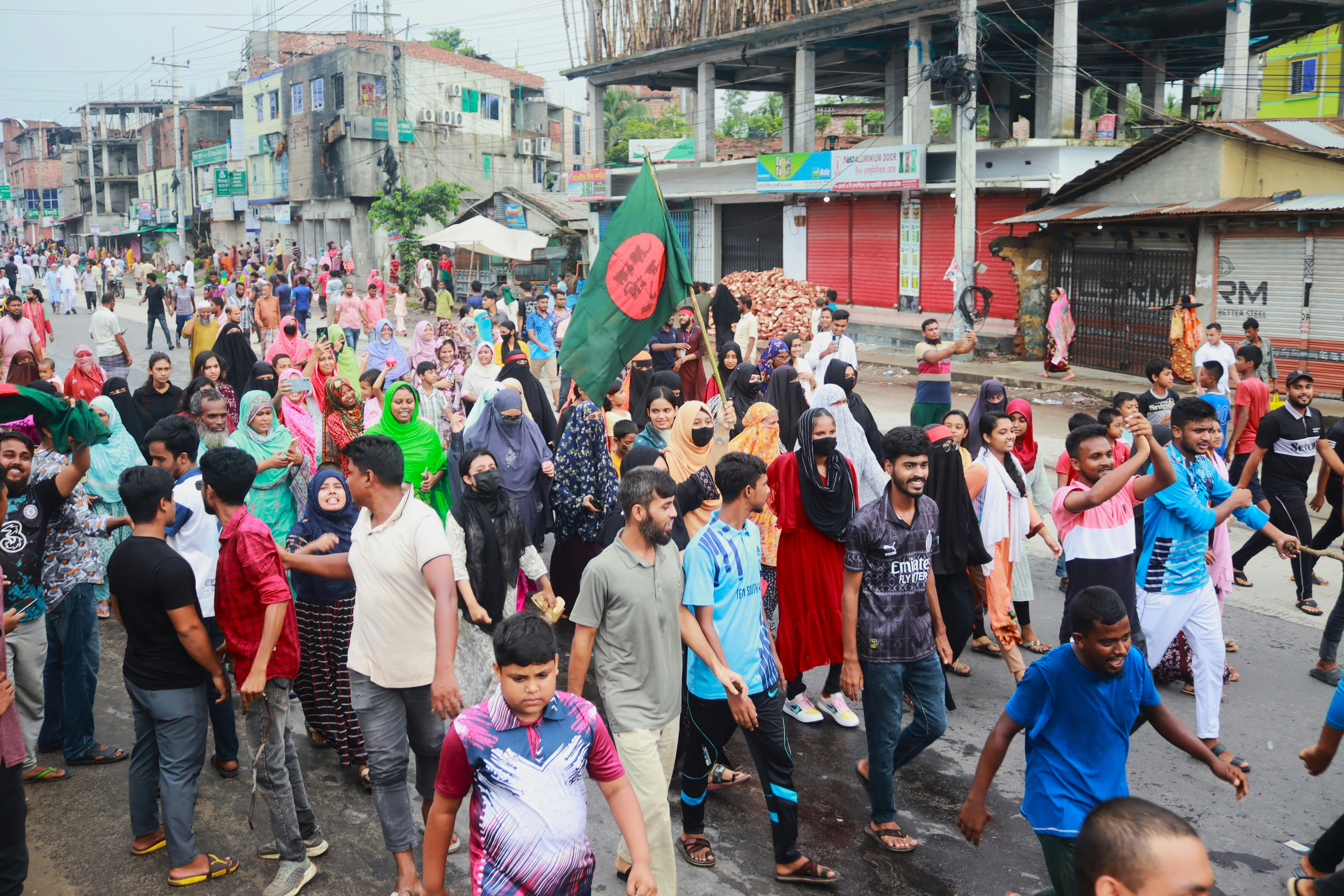 A large group of people walking down a street
