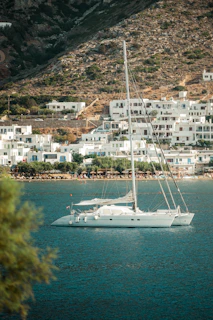 A white boat floating on top of a body of water