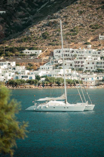 A white boat floating on top of a body of water