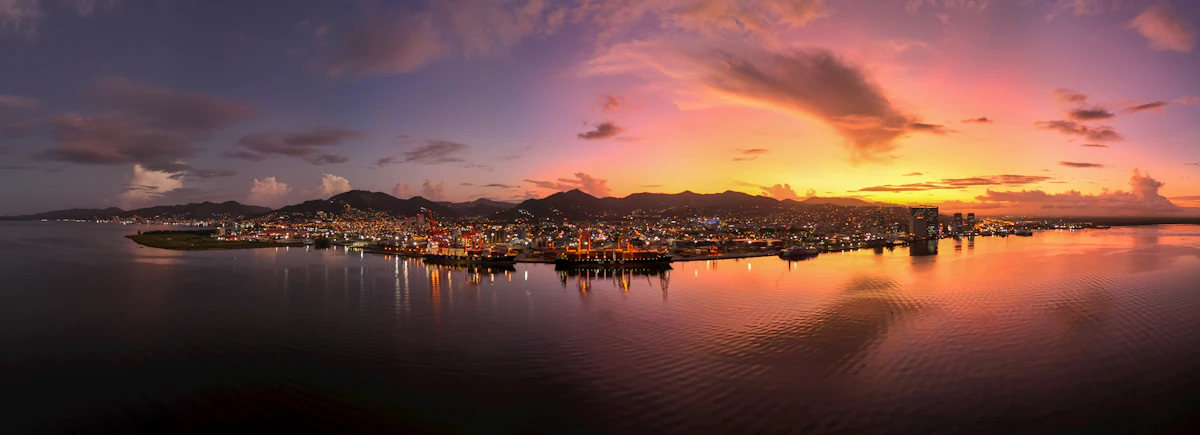 Sunrise over the harbour at Port of Spain, Trinidad, with boats on calm water and no people visible