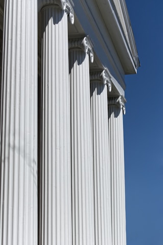 A row of white pillars against a blue sky