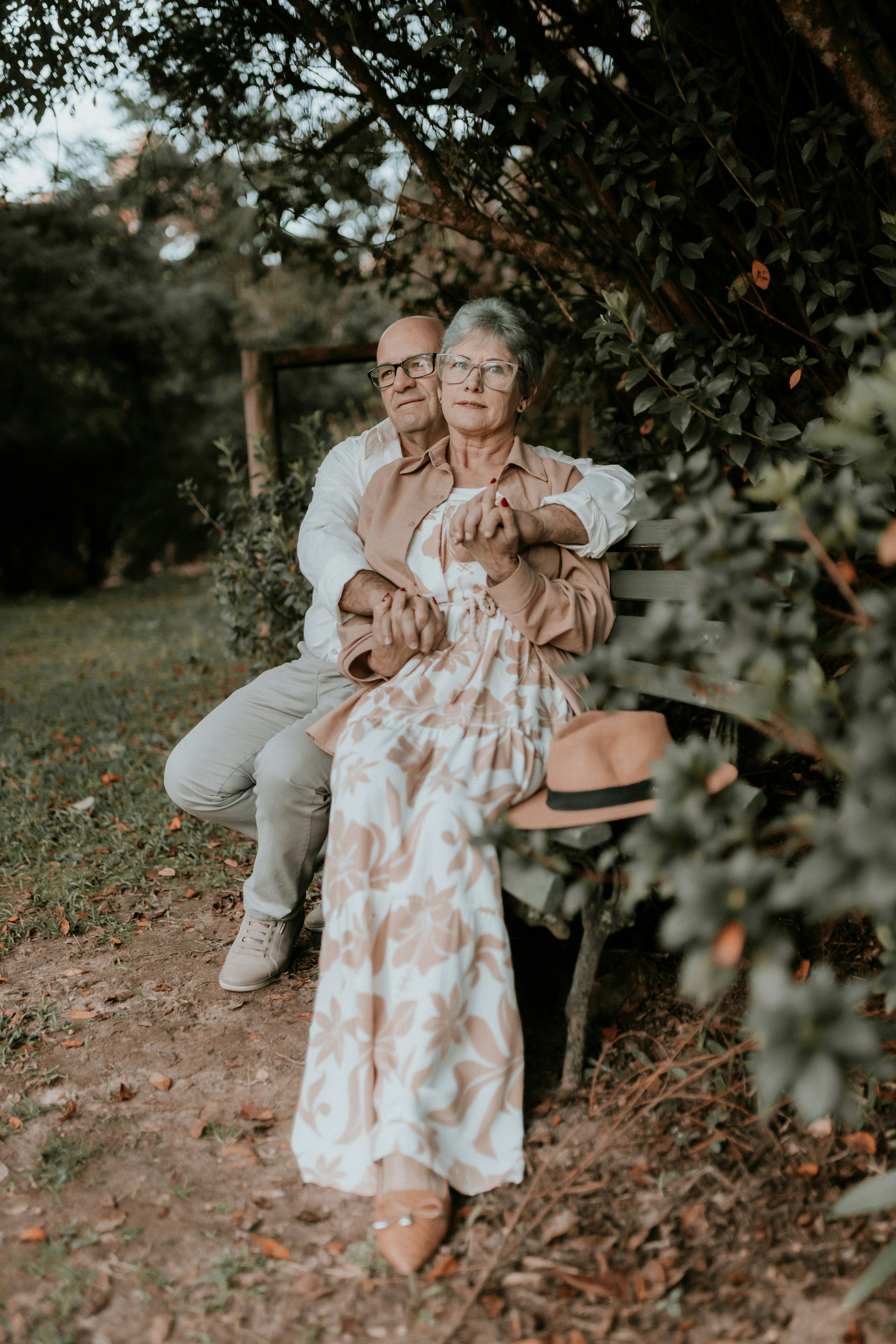An older couple sitting apart outdoors, reflecting the rise of grey divorce