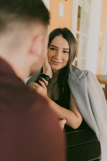 A woman sitting at a piano smiling at a man