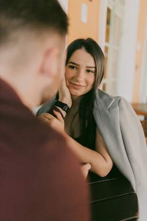 A woman sitting at a piano smiling at a man
