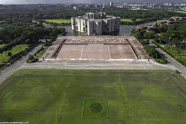 An aerial view of a large building in the middle of a field