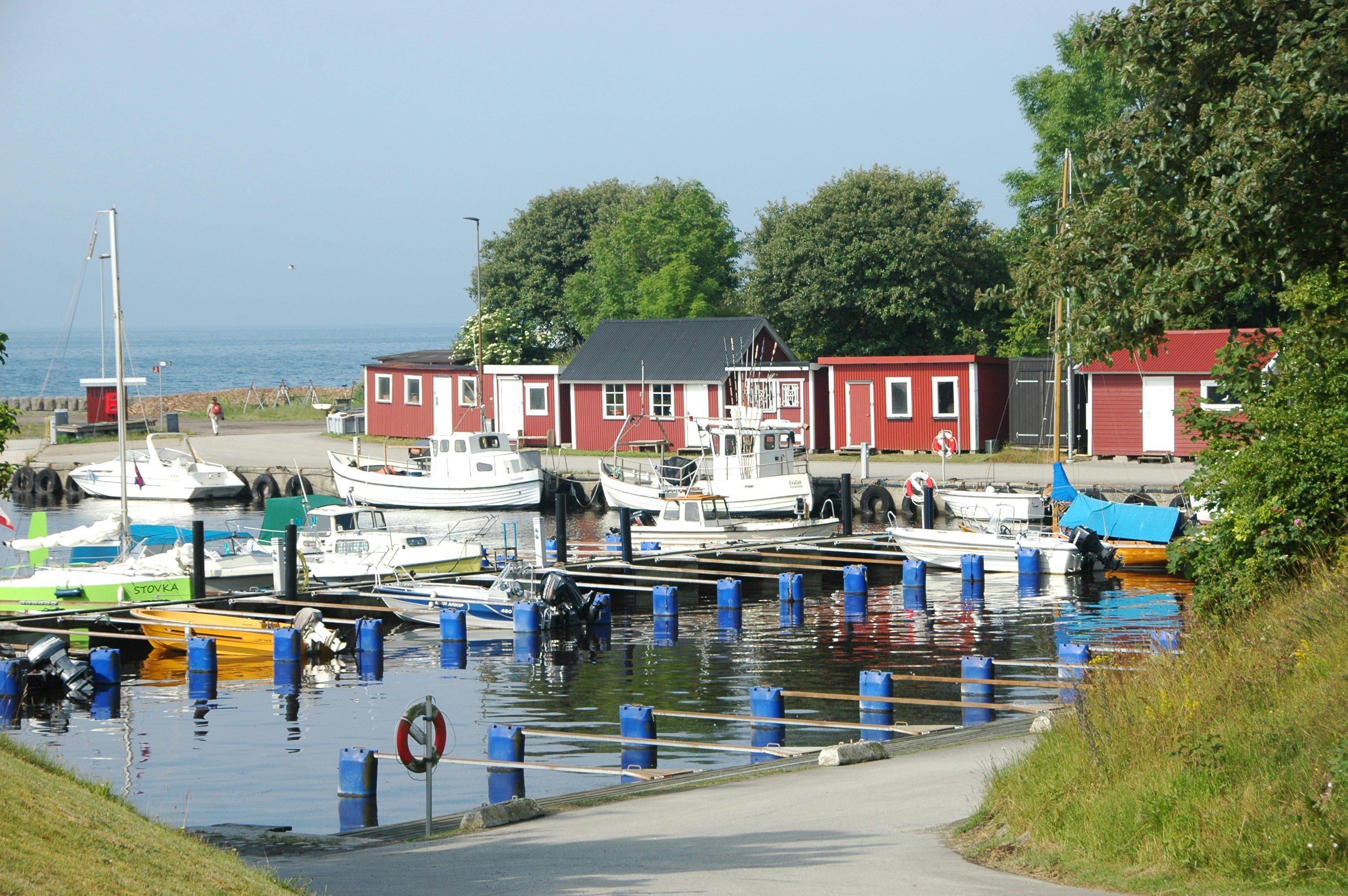 Harbor with boats and green hillside