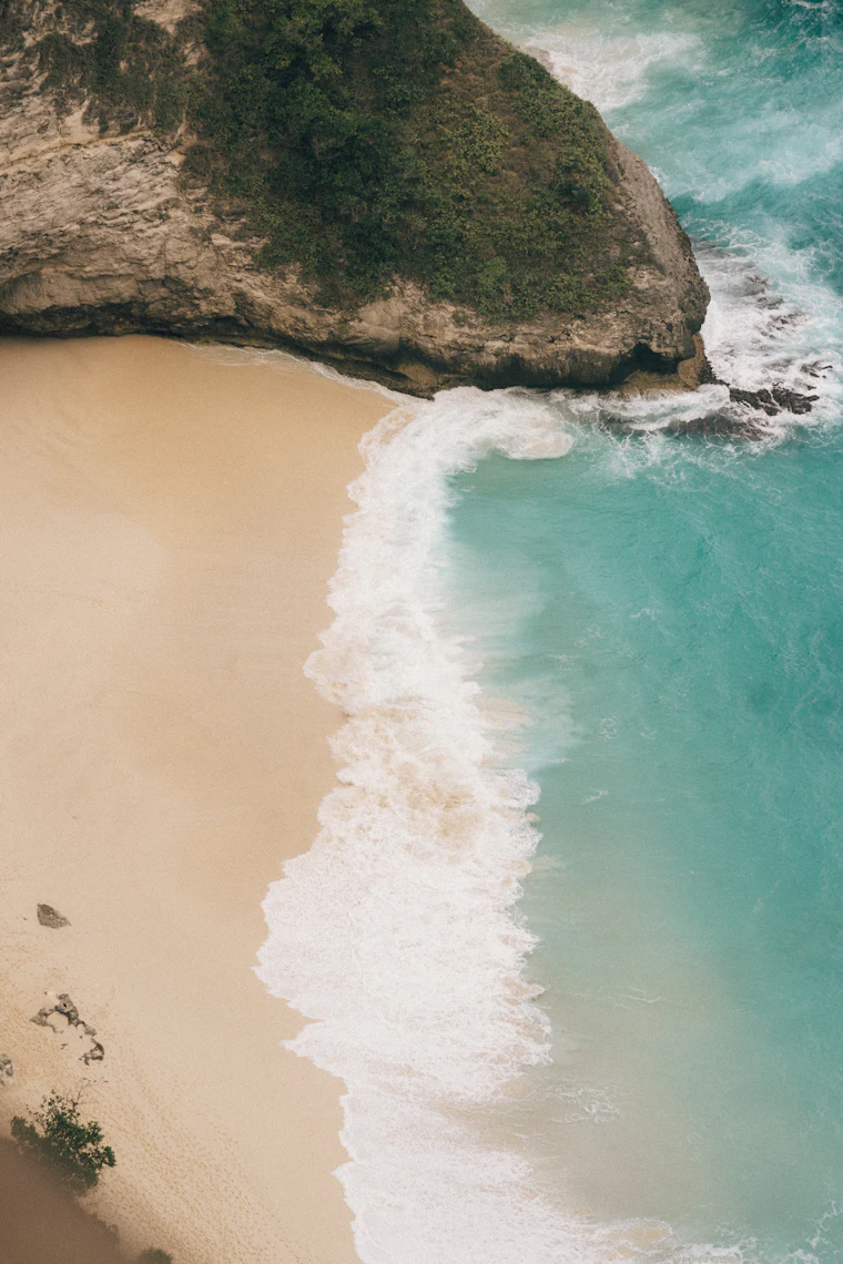 Aerial view of a Bali beach and cliff