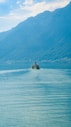 A small boat in the middle of a large body of water