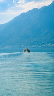 A small boat in the middle of a large body of water
