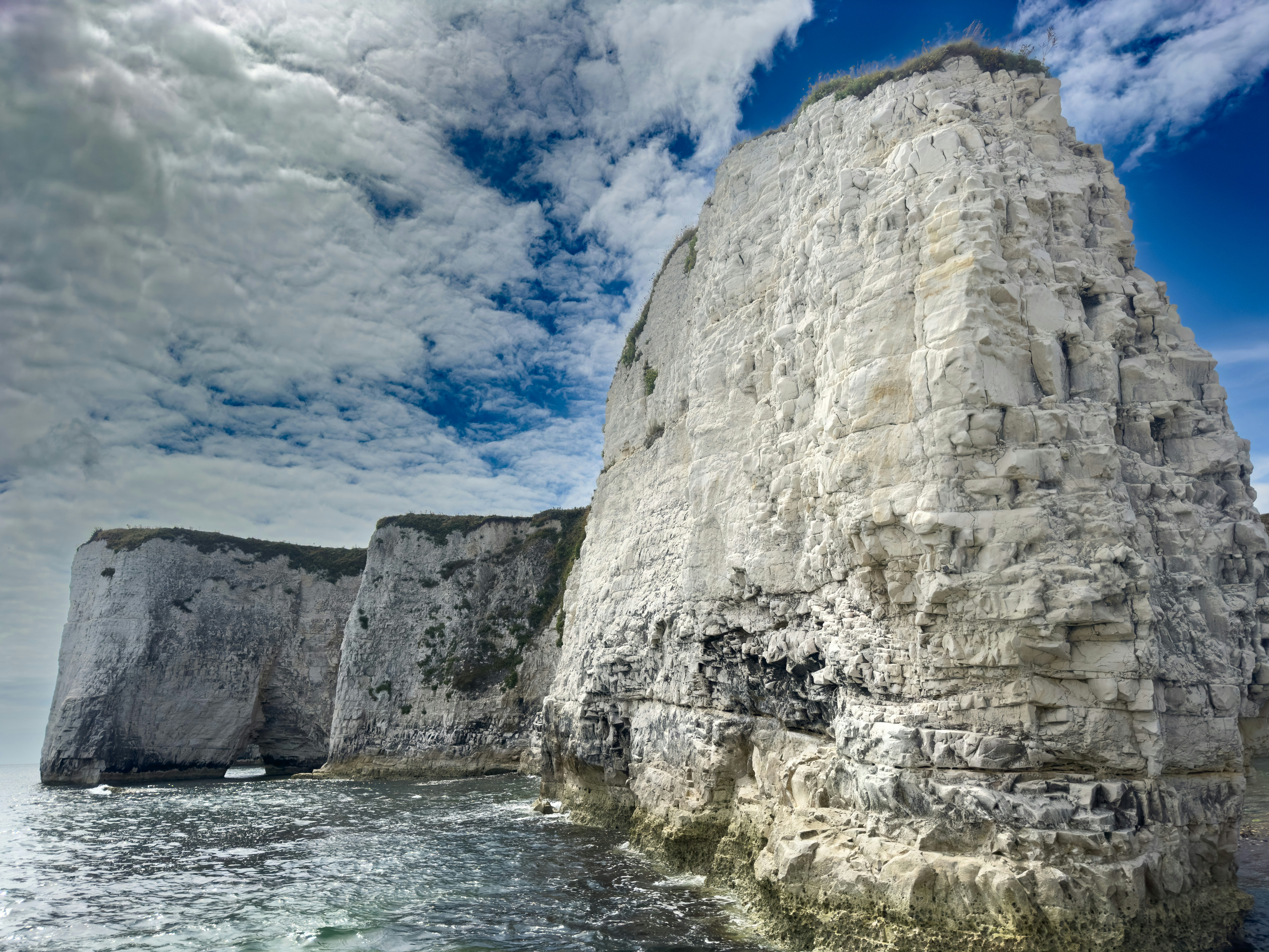 A large rock sticking out of the ocean
