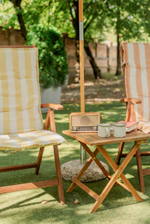 A couple of lawn chairs sitting under an umbrella