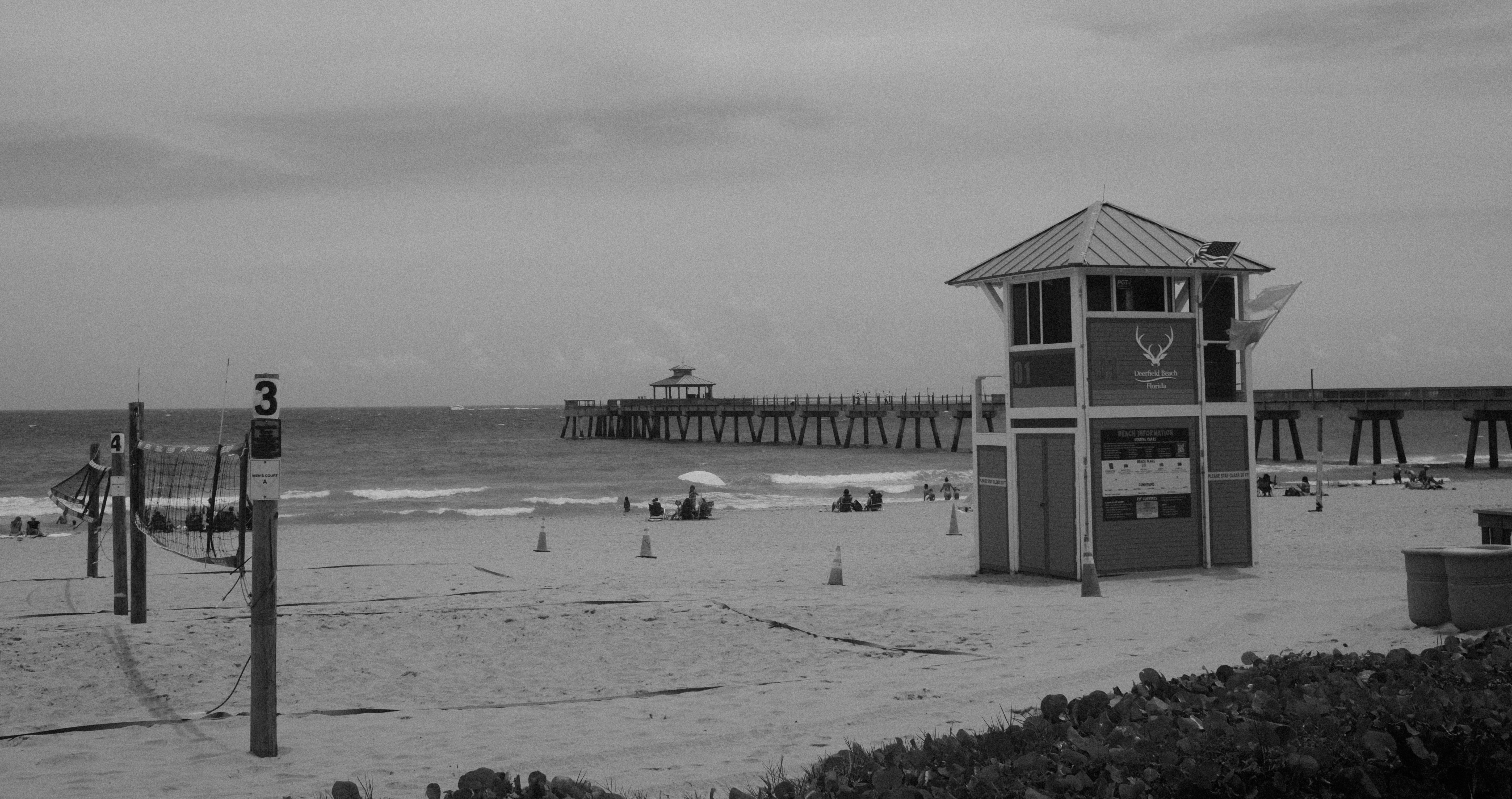 A black and white photo of a lifeguard tower on a beach (Photo by Angelina Kusznirewicz on Unsplash)