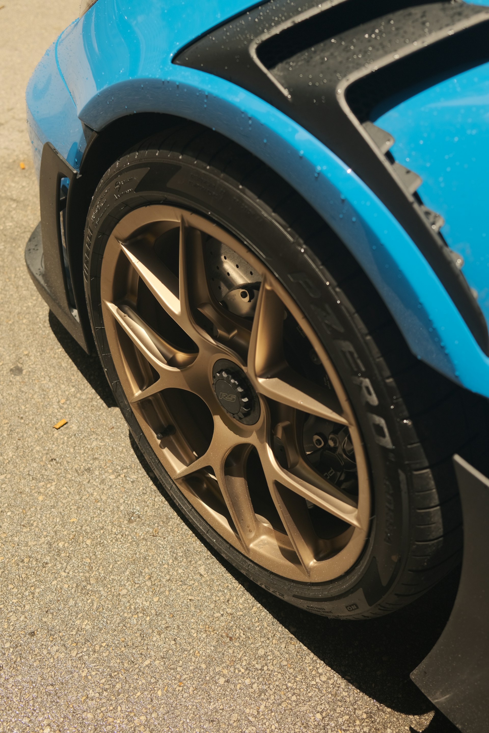 A blue sports car parked on the side of the road