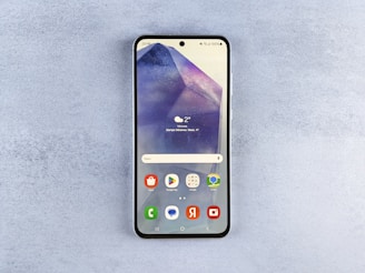 A close up of a cell phone on a surface