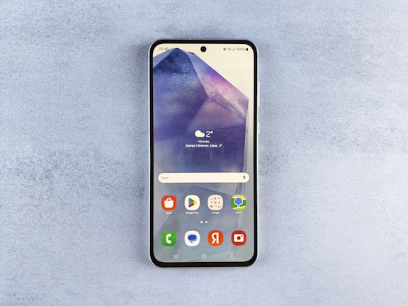 A close up of a cell phone on a surface