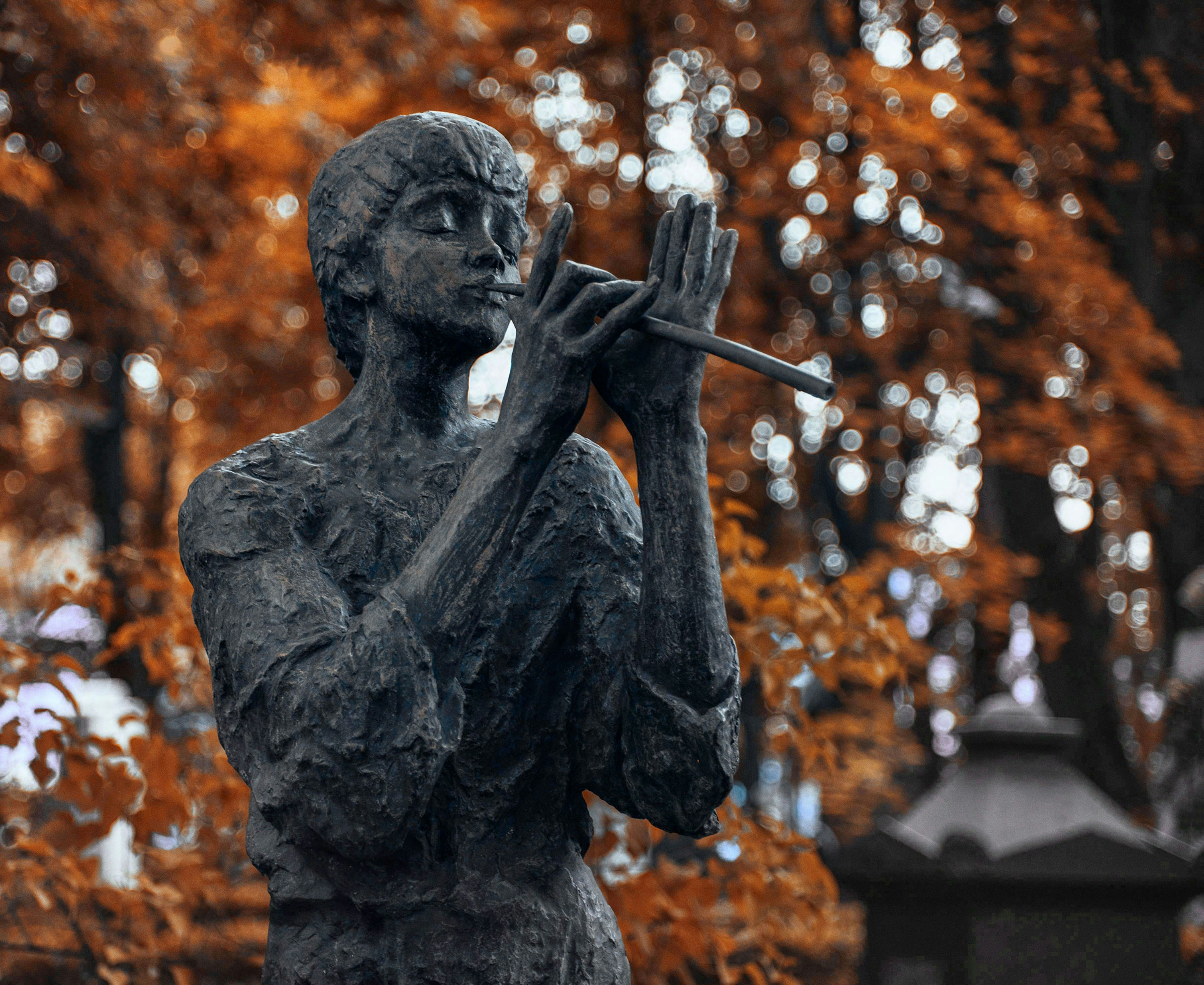 A statue of a man holding a flute