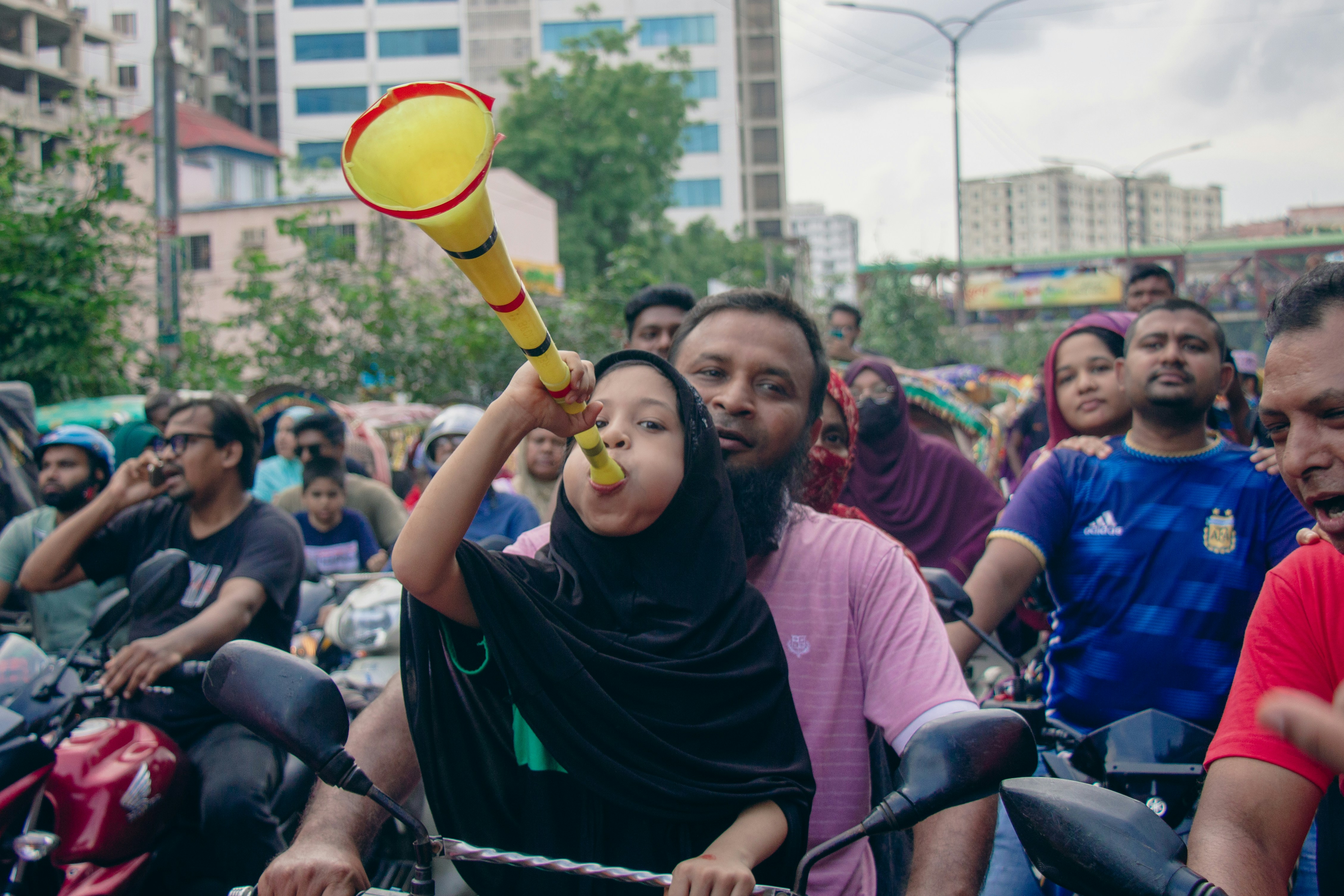 a group of people riding bicycles down a street