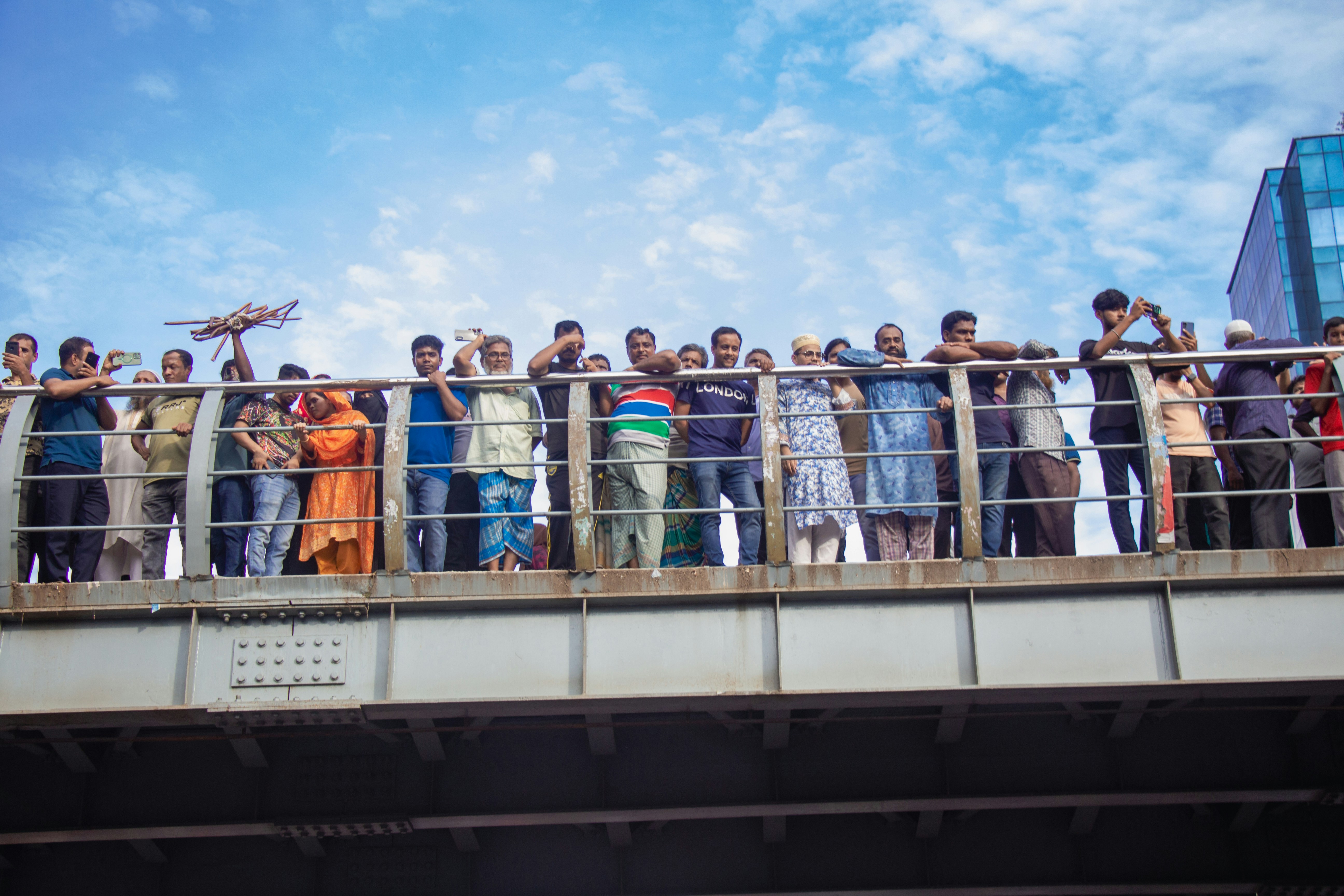 A group of people standing on a bridge