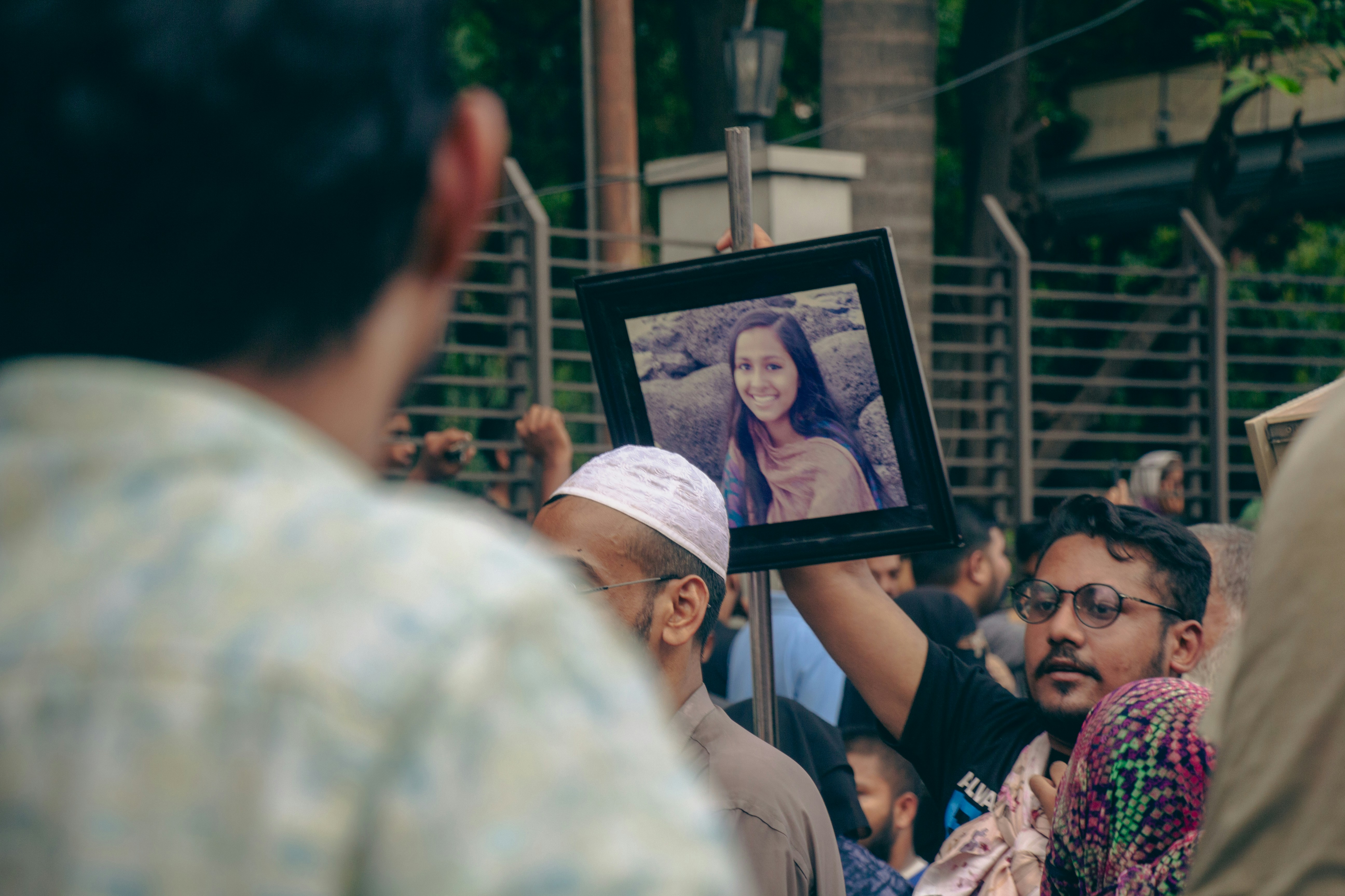 A man holding up a picture of a woman