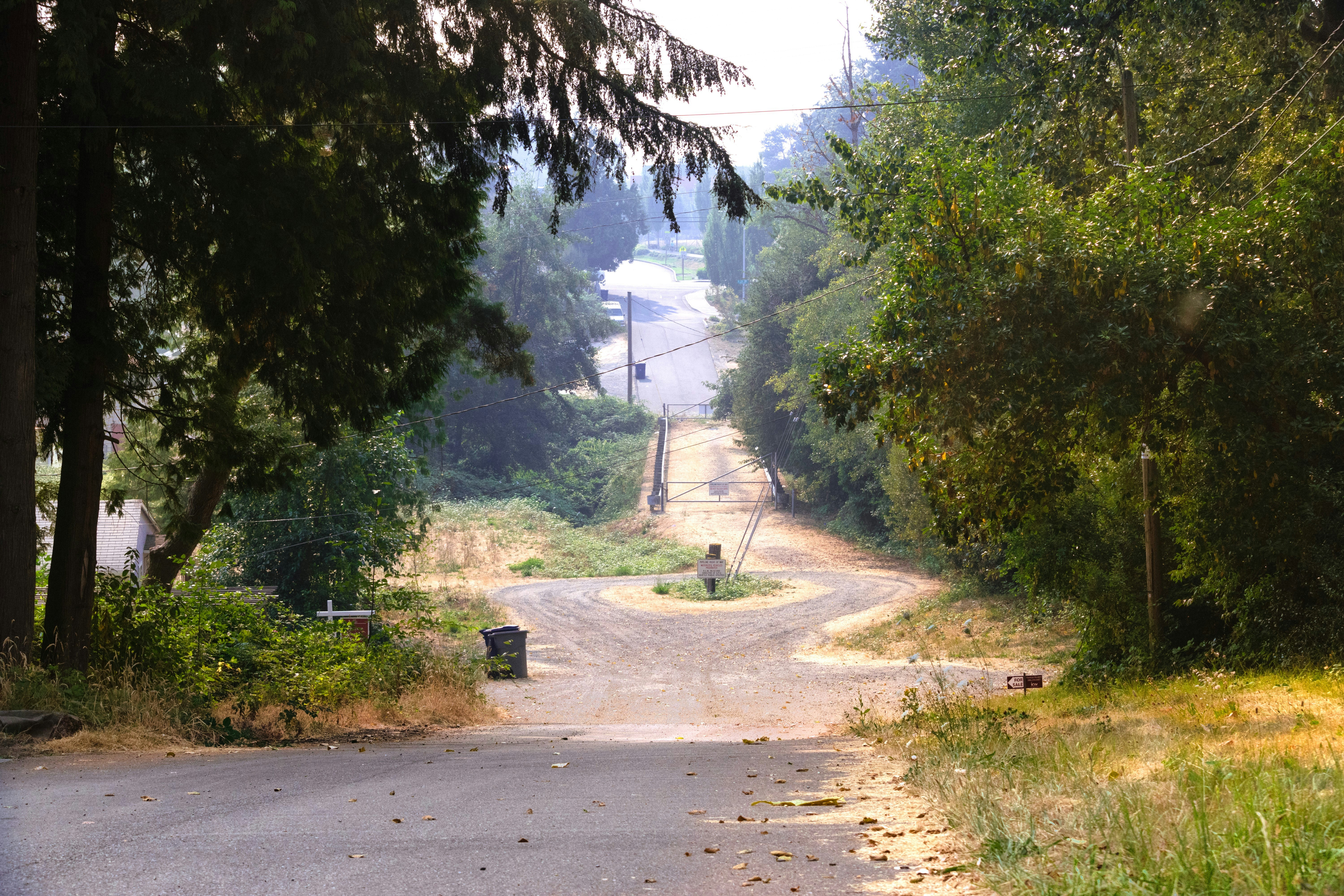 A person riding a motorcycle down a dirt road