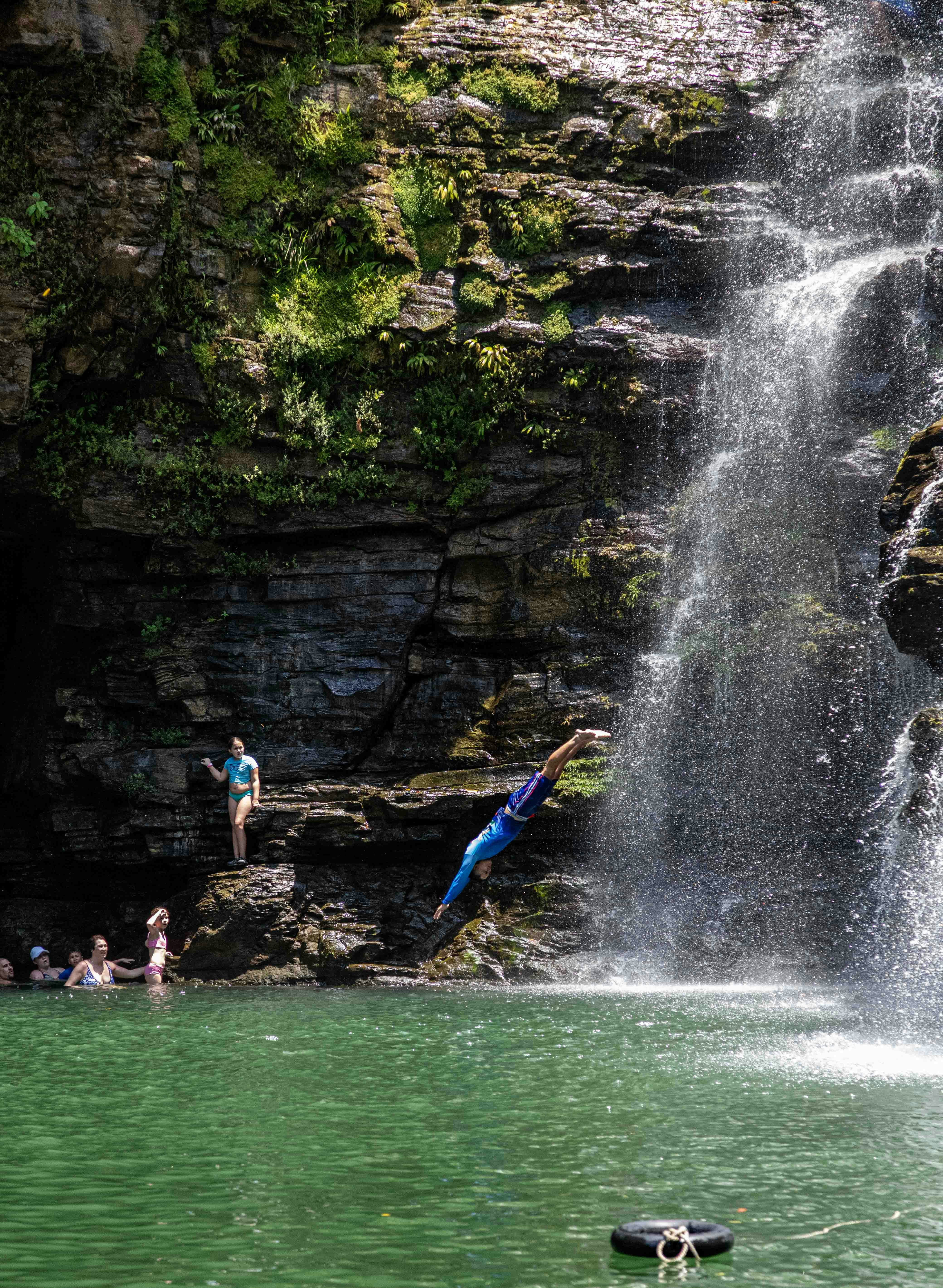A man falling off a cliff into a body of water