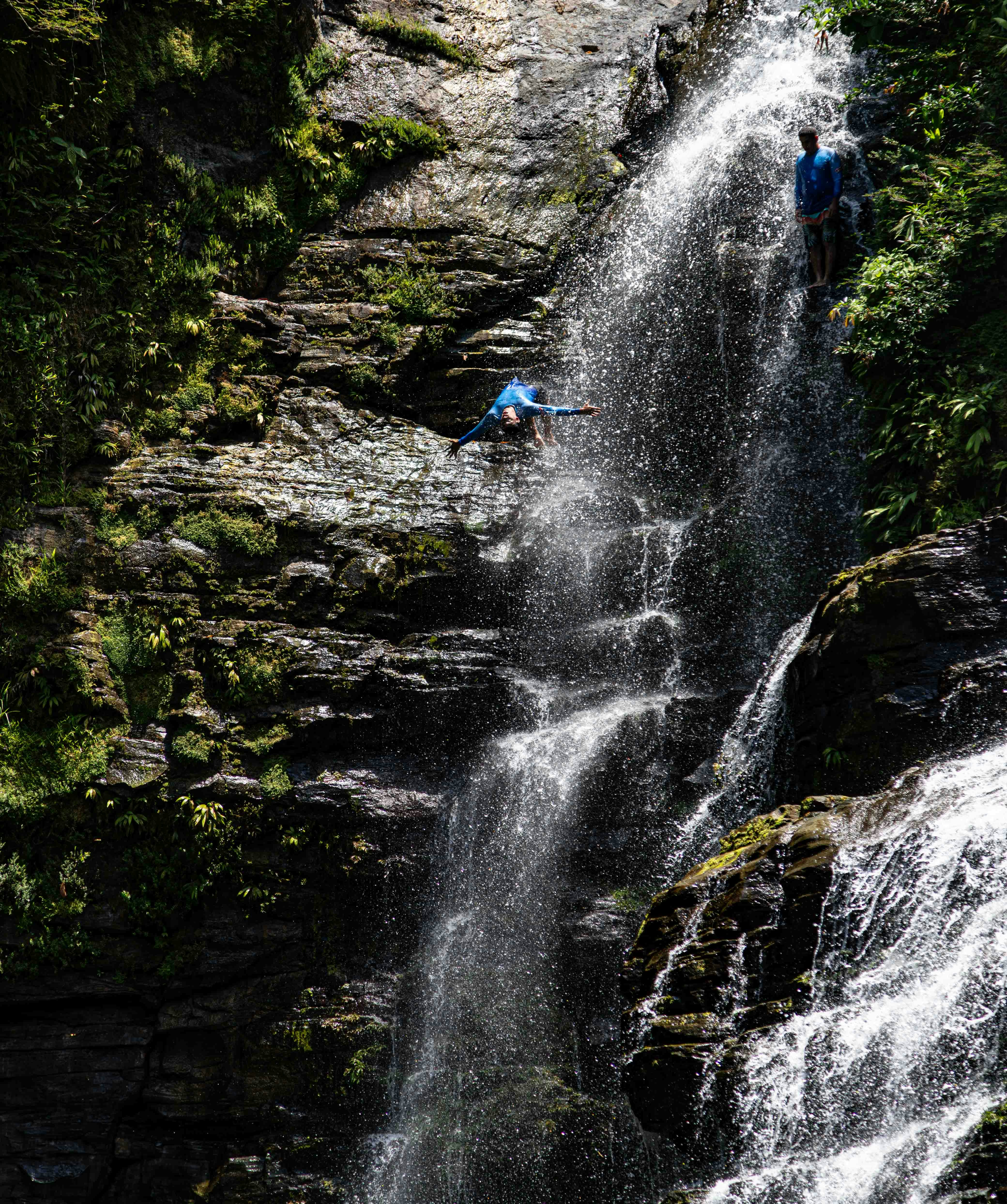 A man standing on top of a waterfall