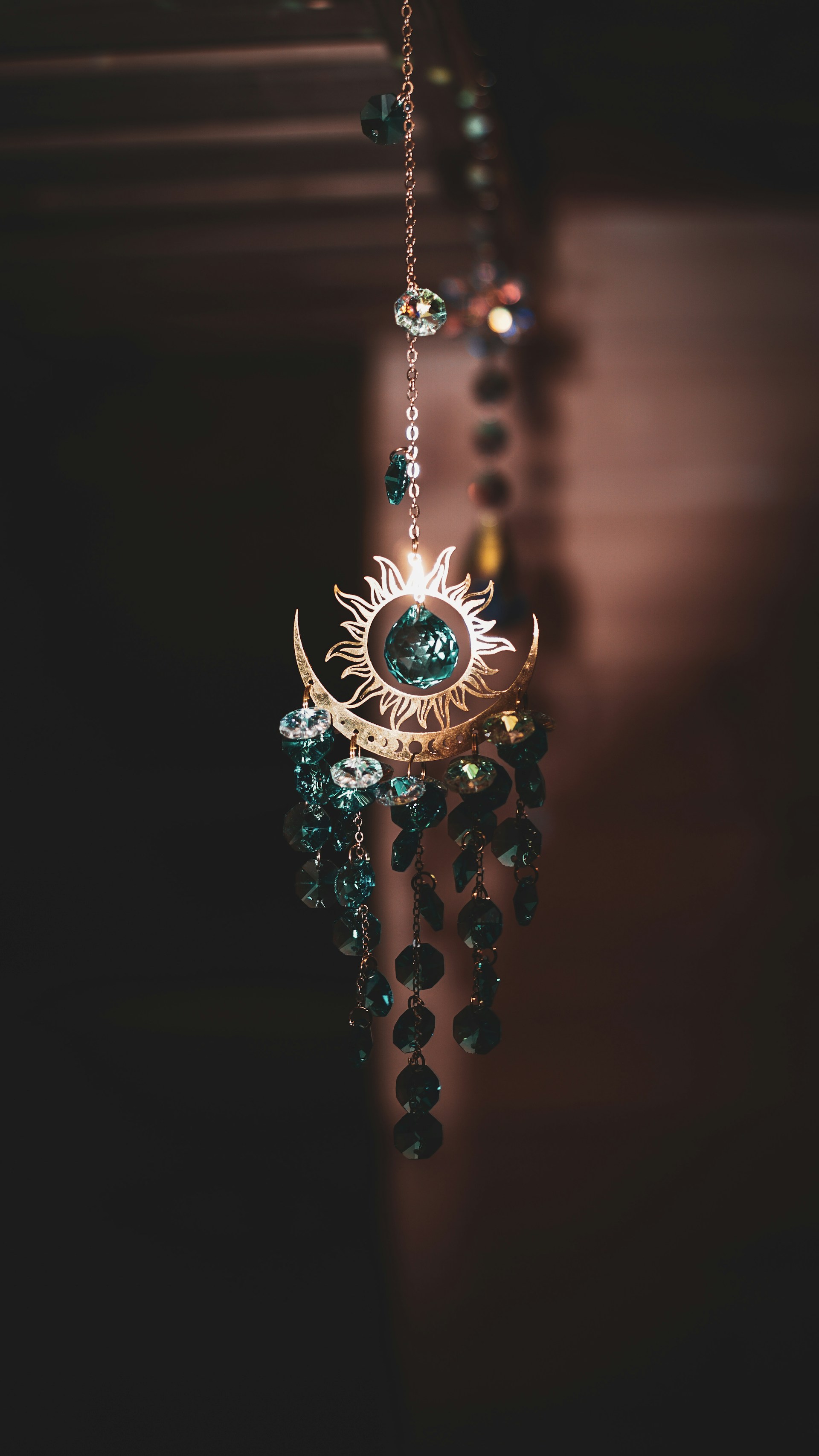 A close up of a wind chime hanging from a ceiling