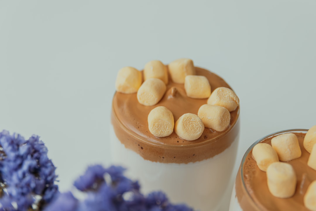 A couple of cups filled with chocolate and marshmallows
