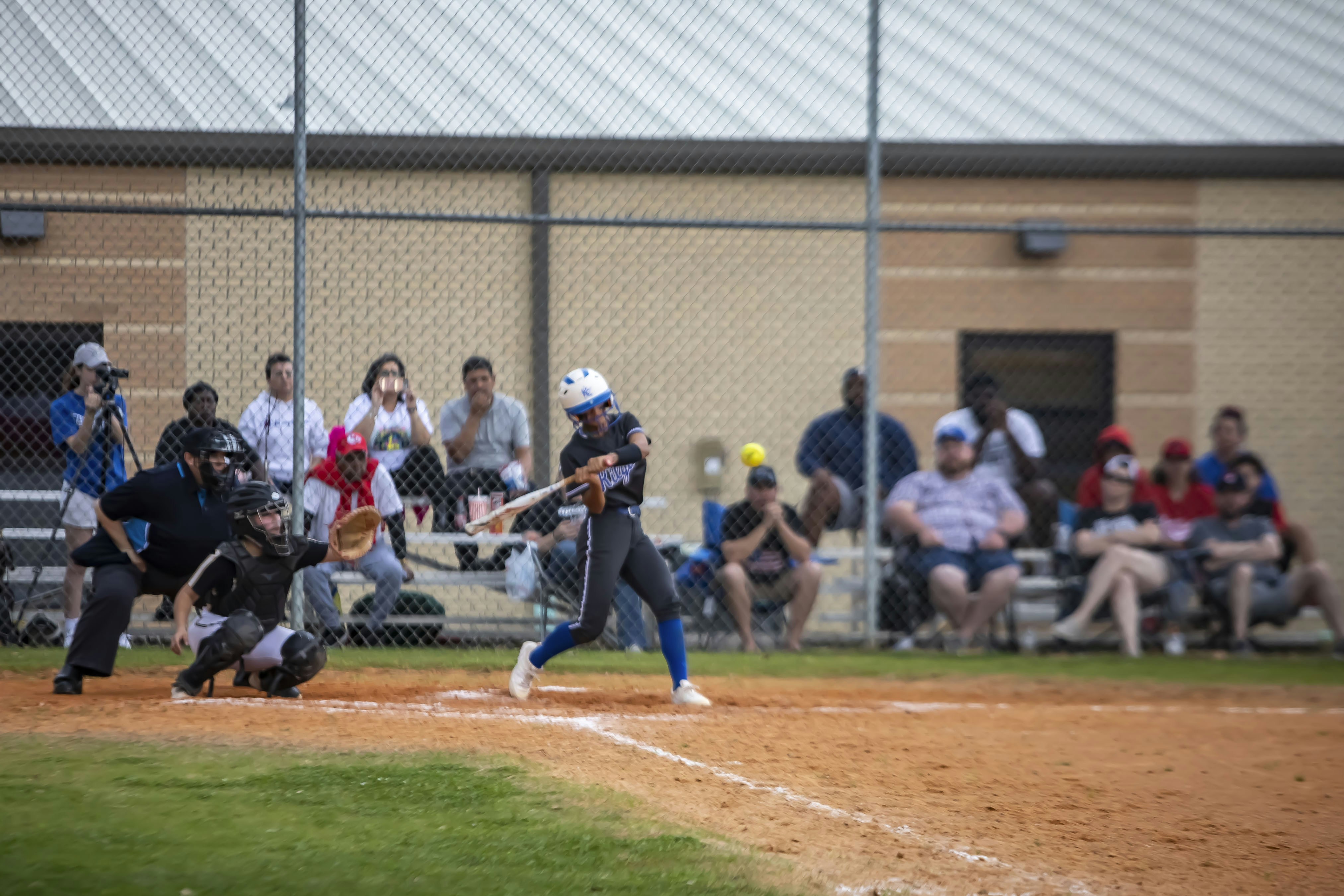 A baseball player swinging a bat at a ball