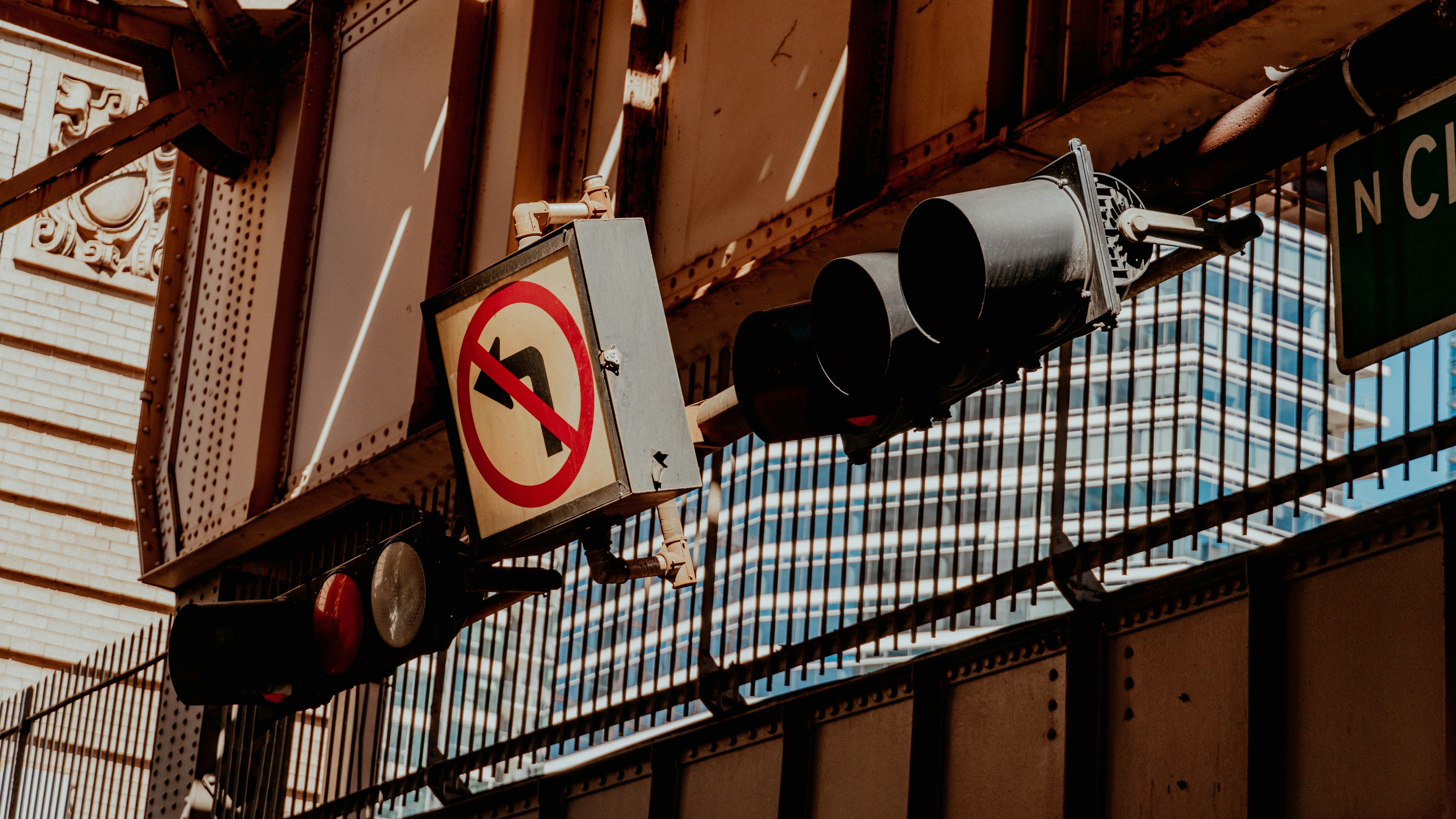 A traffic light hanging from the side of a building