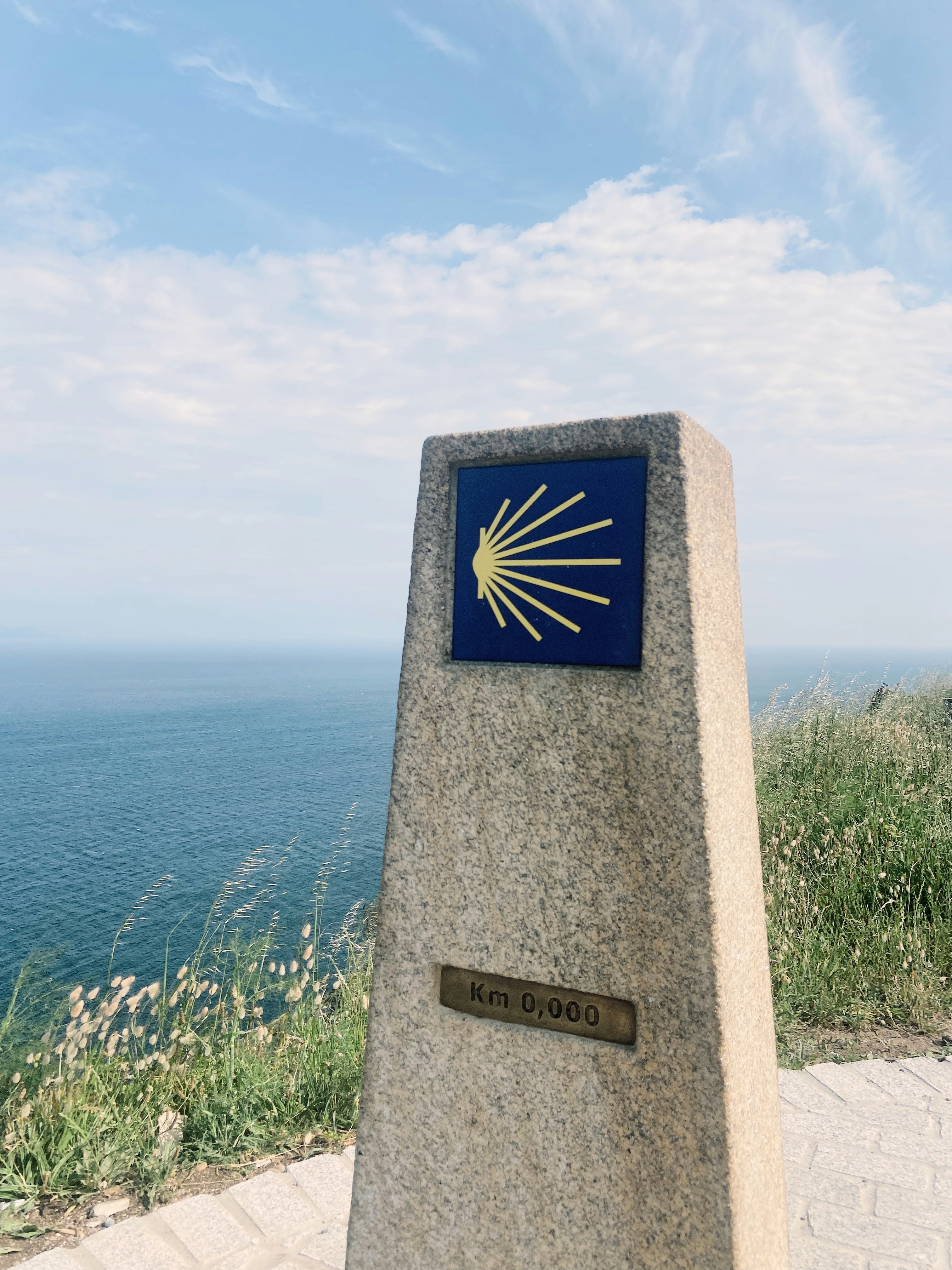 A stone monument with a blue and gold sun on it