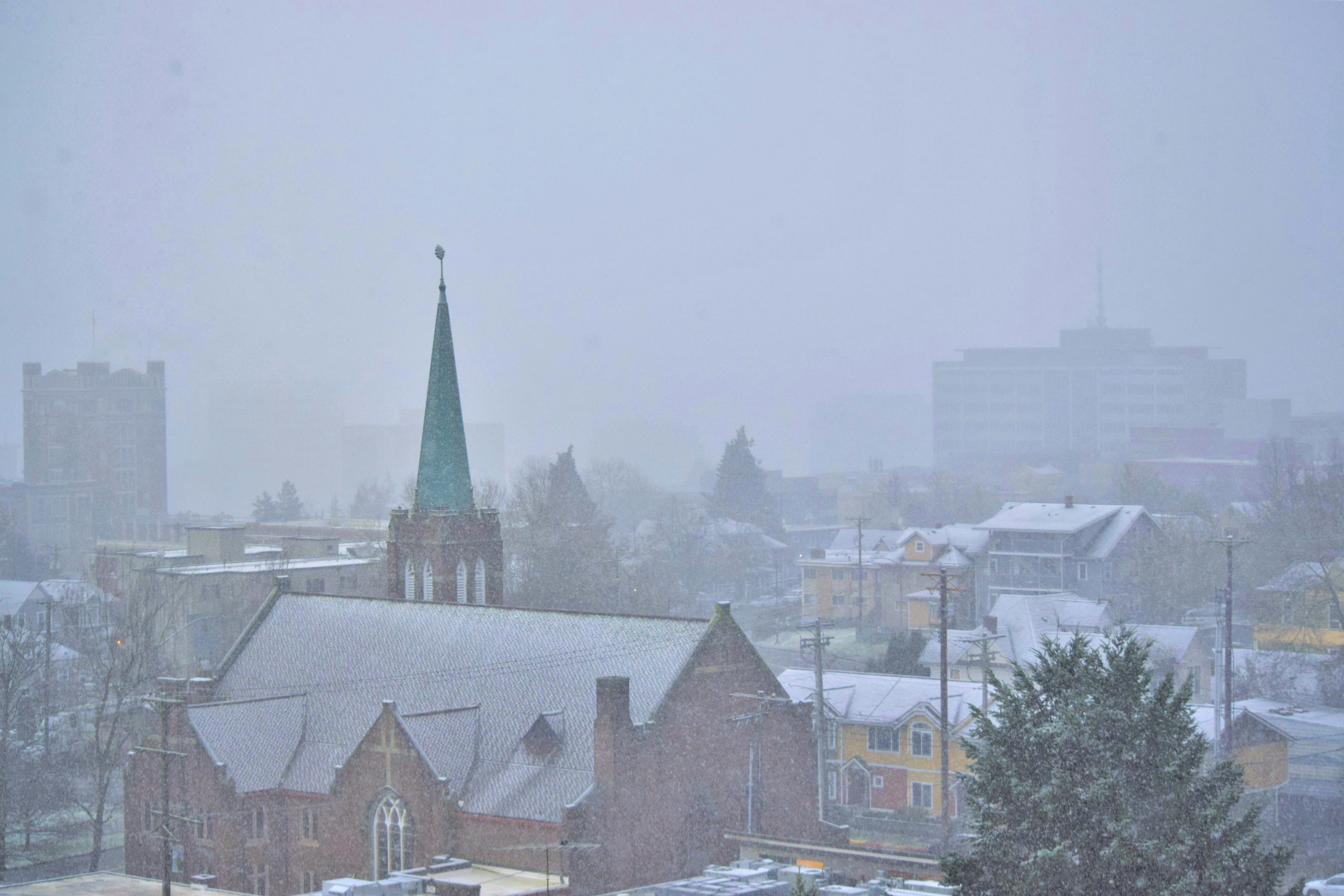 A church with a steeple in the snow