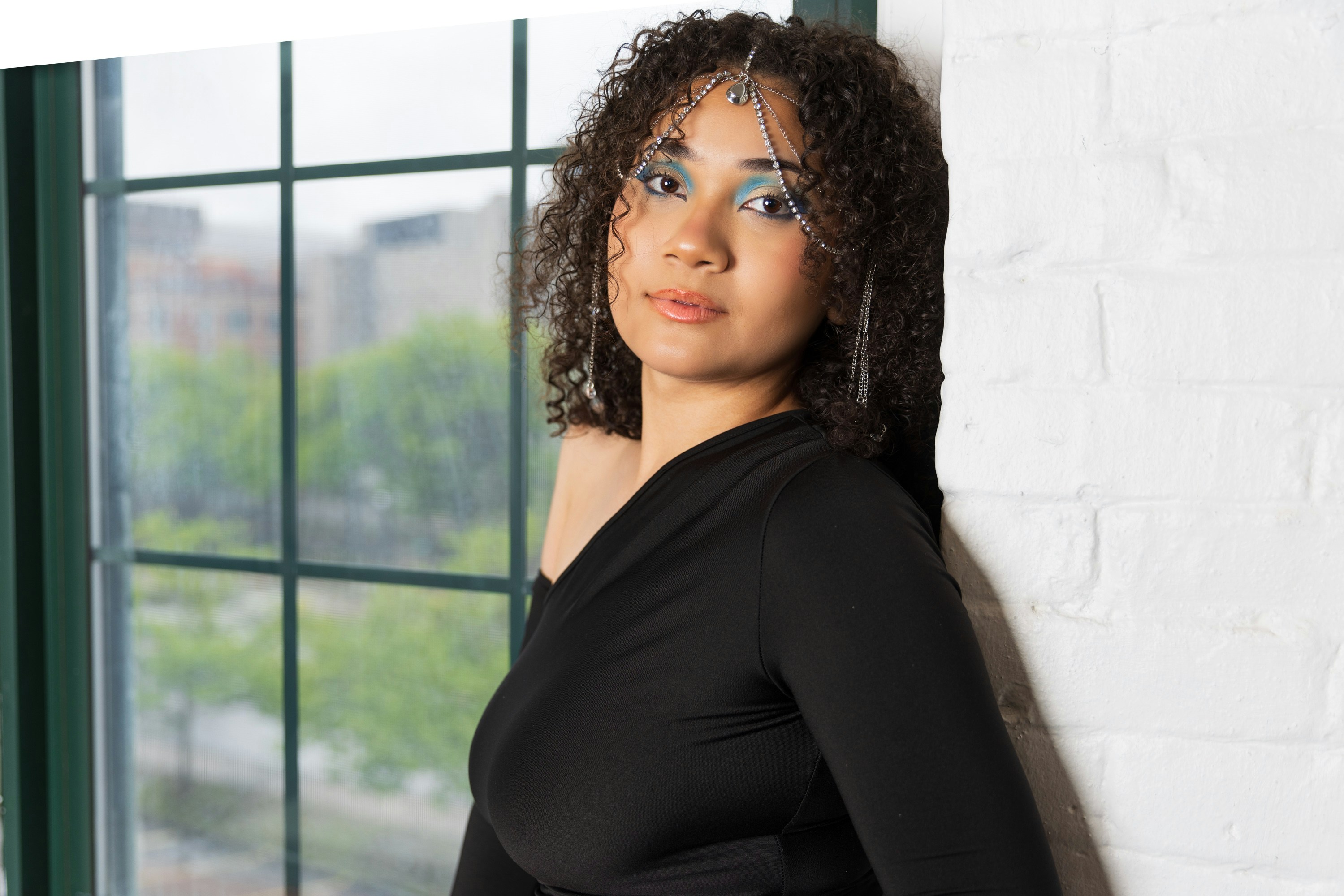 A woman standing in front of a window