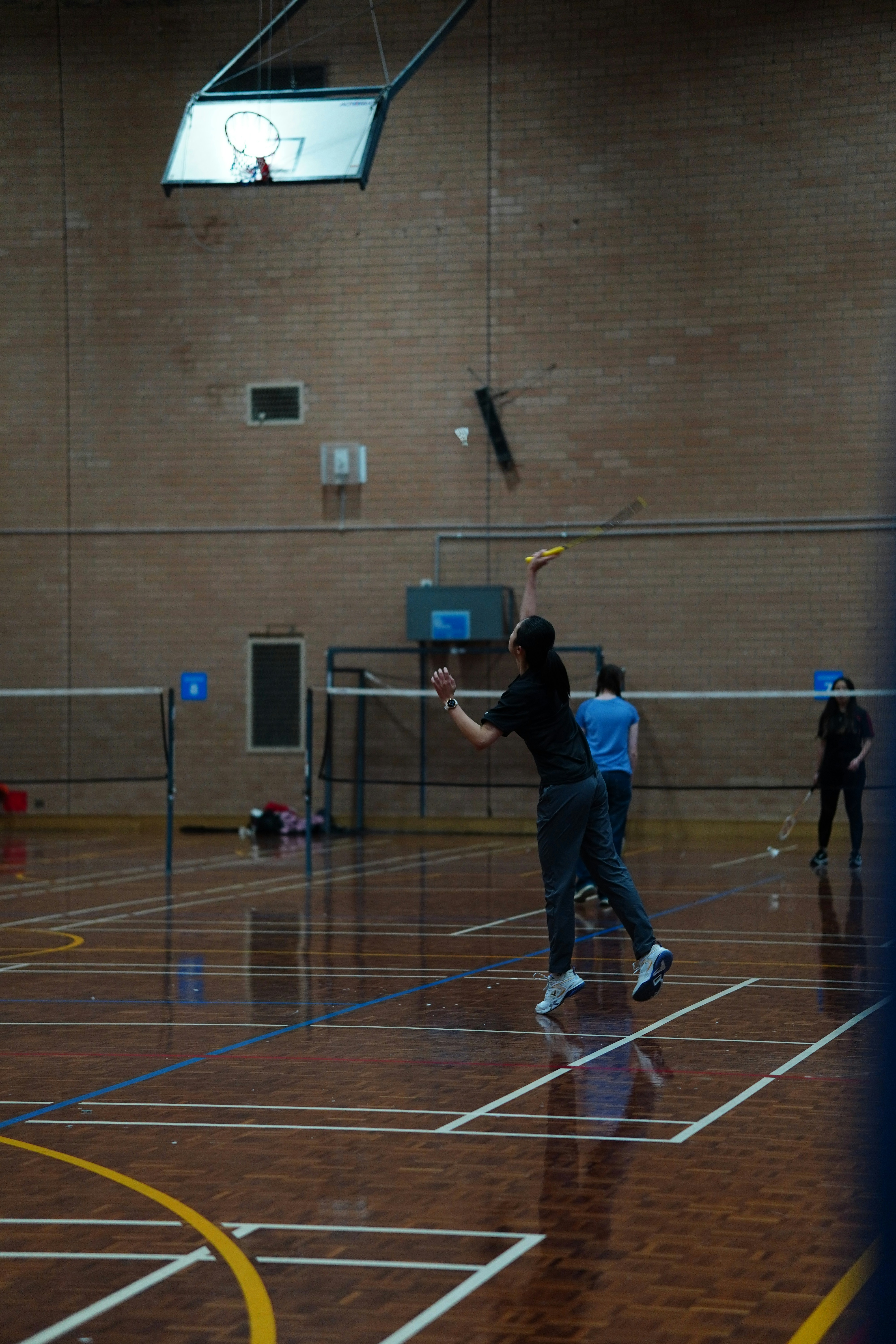 A group of people playing a game of badminton