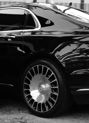 A black car parked in front of a building