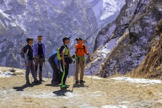 A group of people standing on top of a snow covered mountain