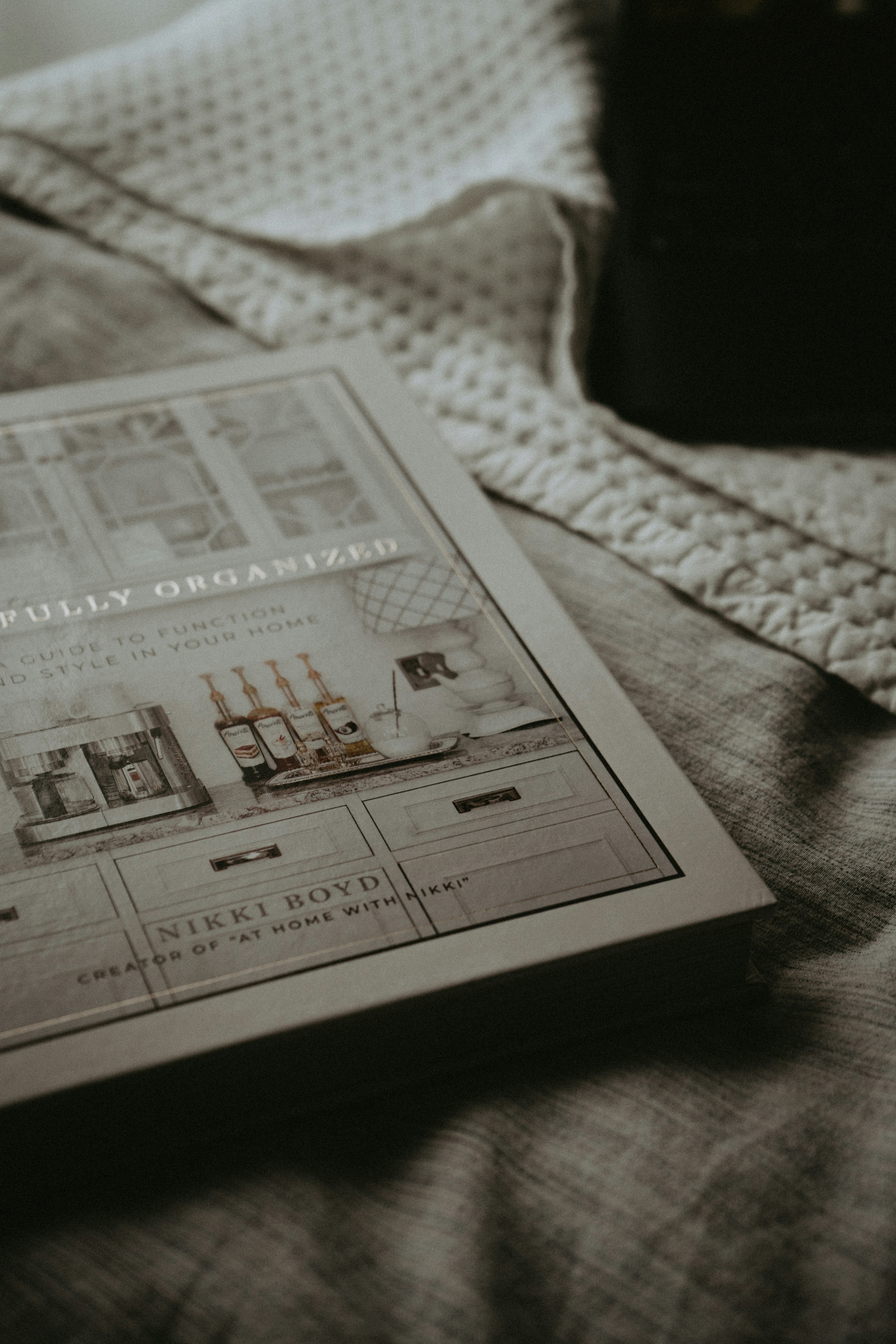 A book sitting on top of a bed next to a camera