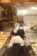 A group of people in a kitchen preparing food