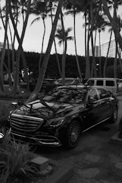 A black and white photo of a car parked in a parking lot