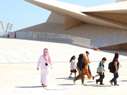 A group of people walking in front of a building