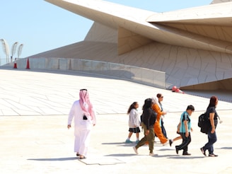 A group of people walking in front of a building