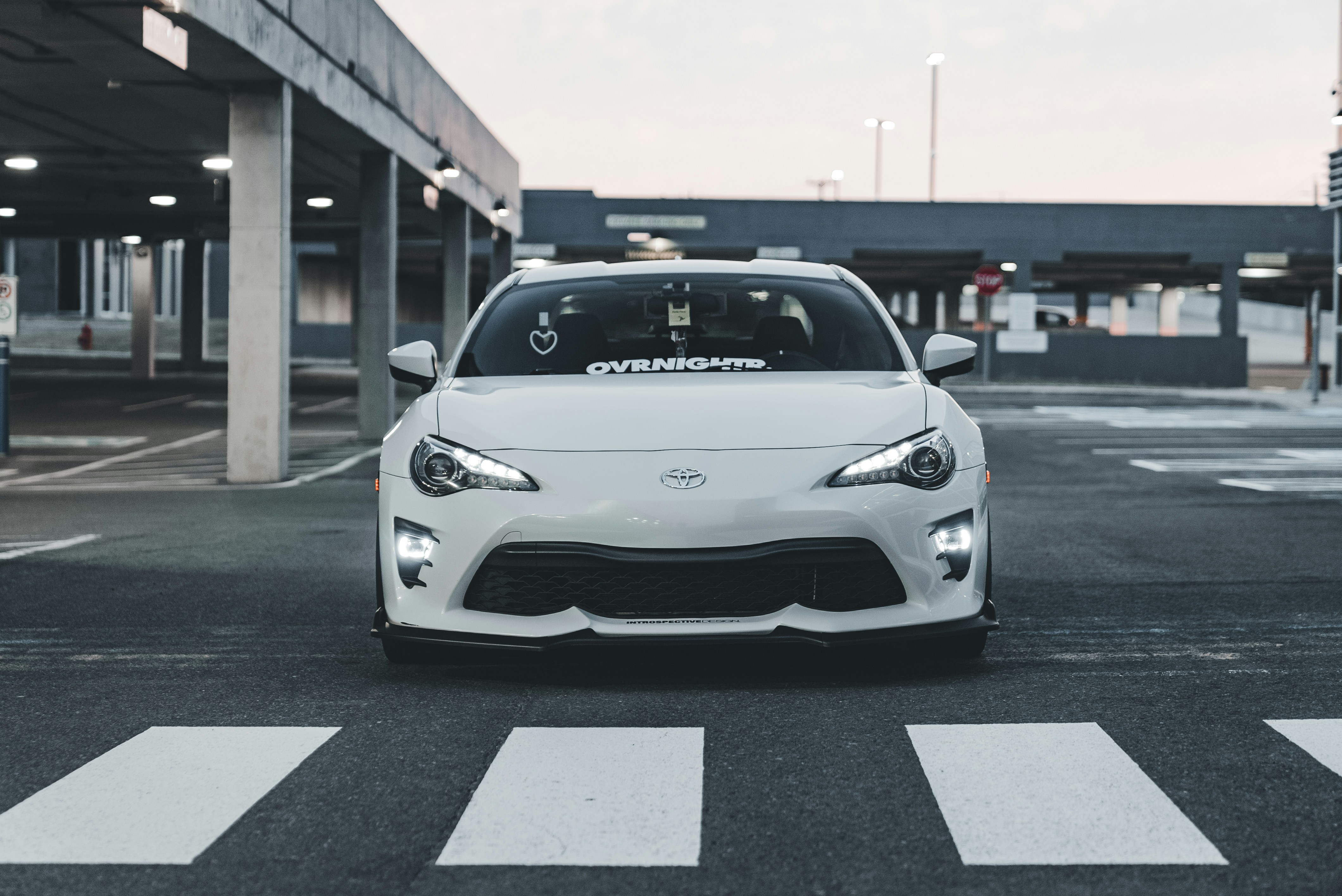 Tesla Model 3 driving on a city street representing everyday commuting costs