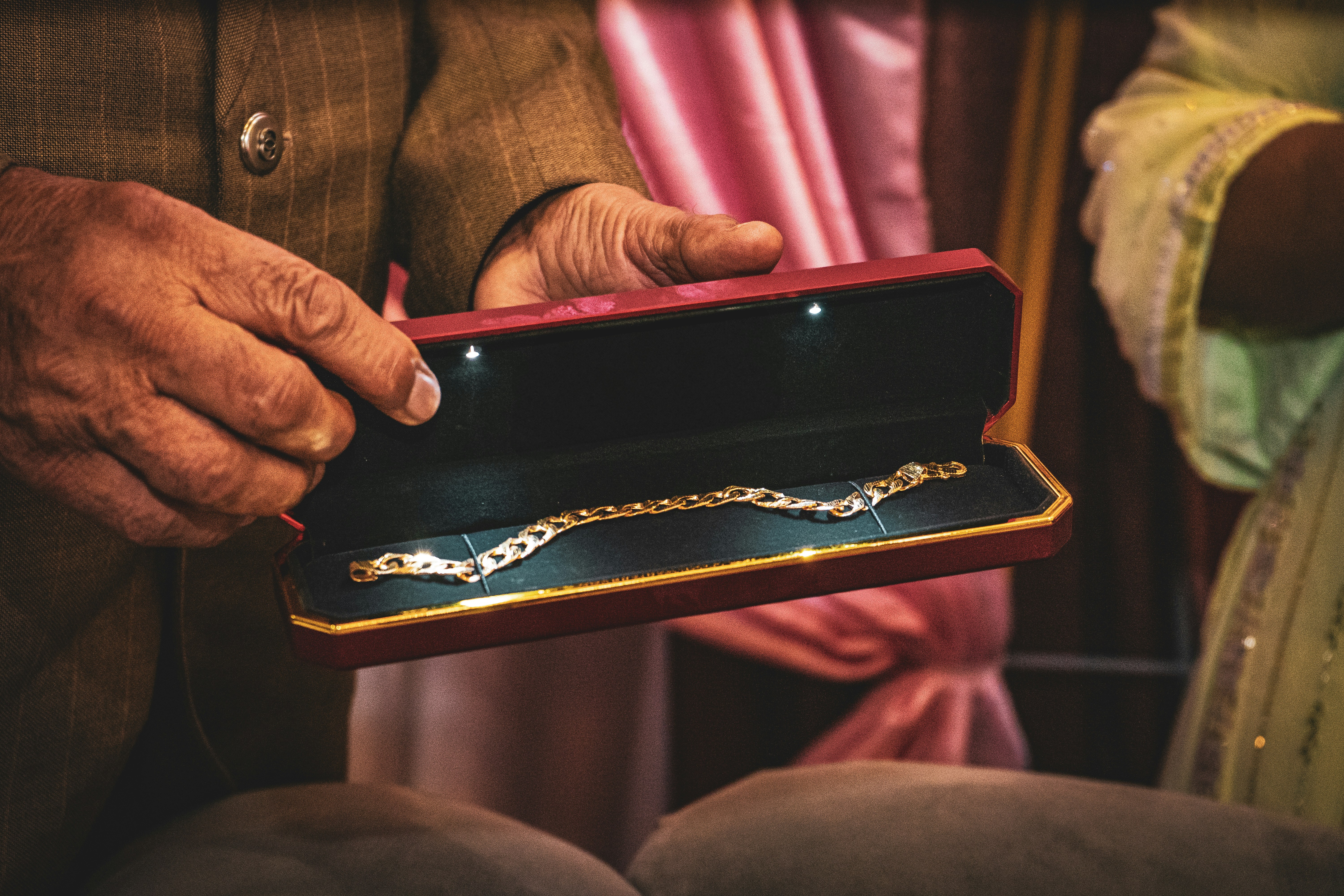 A man holding a box with a chain on it