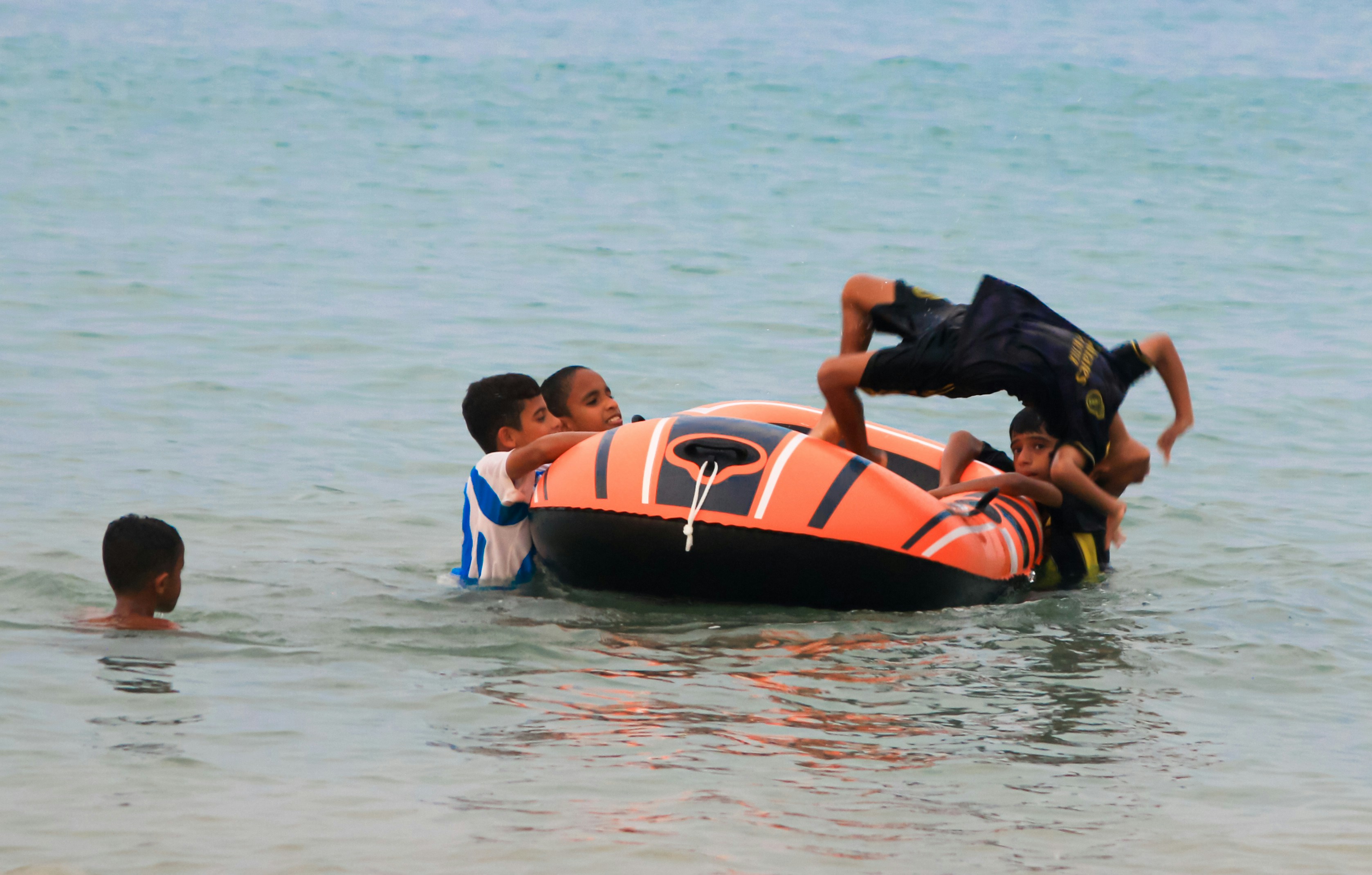 A group of people riding on the back of an inflatable boat