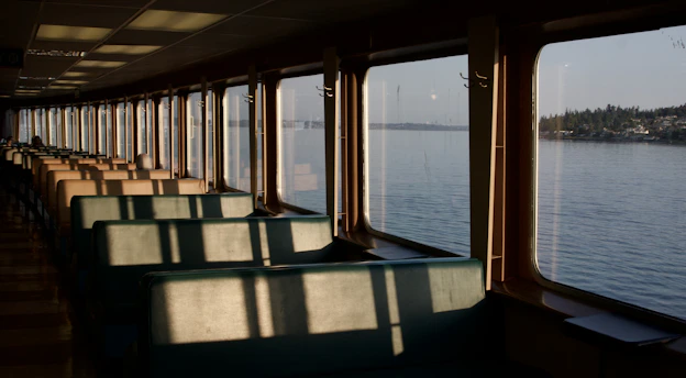 A long row of seats sitting on top of a boat