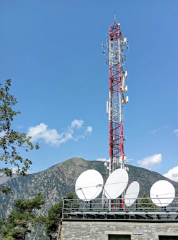A very tall tower with some antennas on top of it
