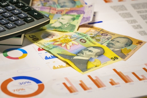 A calculator sitting on top of a pile of money