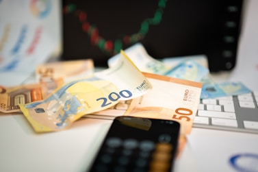 A cell phone sitting on top of a pile of money